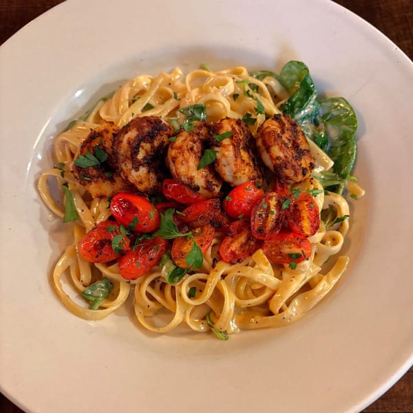 Nonna's Italian Ristorante's creamy fettuccine pasta with blackened shrimp, roasted tomatoes, and fresh parsley.