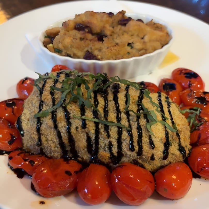 Breaded chicken or fish with balsamic glaze, basil, roasted tomatoes, and a side of stuffing.